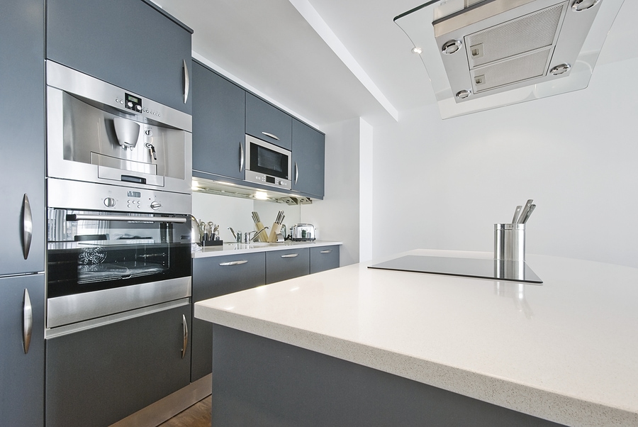 modern contemporary kitchen with built in appliances including coffee machine