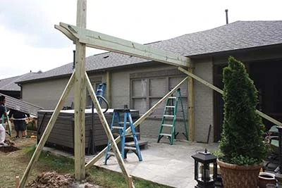 Use 2x4 braces to hold the support structure plumb and square while building the pergola. 