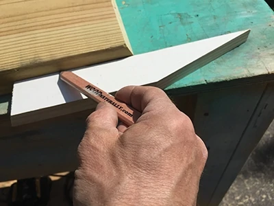 Using a 1x to mark the 2x for the half-miter on shelf material is easier than measuring. 