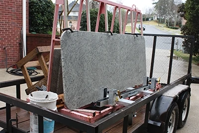 The granite slabs are transported on special racks that reduce vibration on the road. 