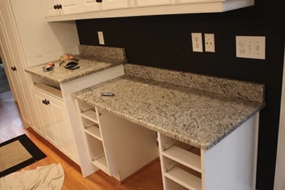 The countertops are held in place by weight, friction and beads of silicone sealant. 