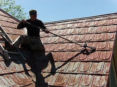 This terne metal roof had hips and valleys that complicated the project. 