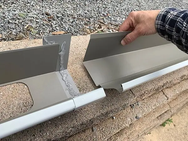 Gutter sections and downspout pieces are joined with 3-in. seamer pieces that are glued in place with gutter sealant.