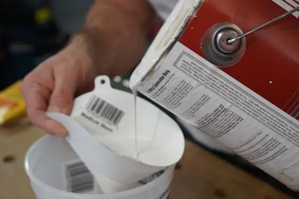 pass old paint through a strainer to remove debris and bits on dried paint