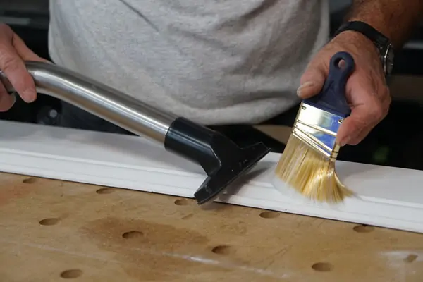 cleaning surface using dry paint brush and vacuum to help eliminate brush strokes of new paint job