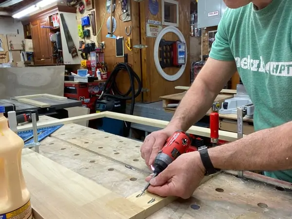 man drilling screws into pocket holes of face frame