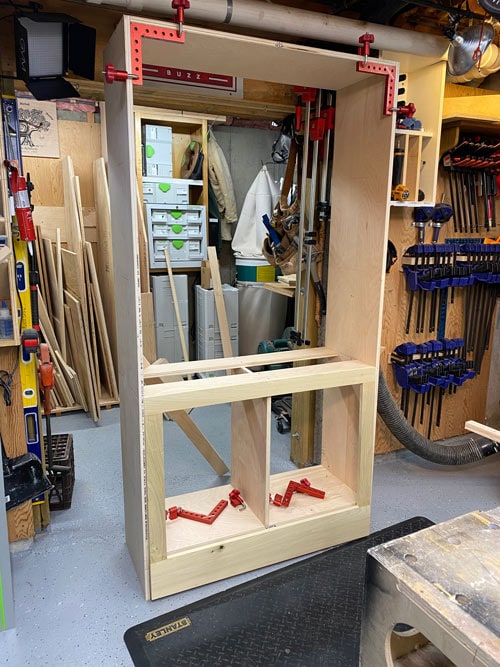 built-in cabinet being assembled in a woodworking shop