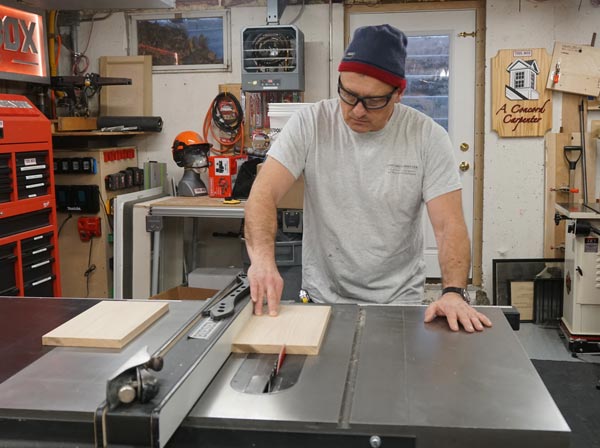 man at table saw cutting piece of oak to create diy step stool