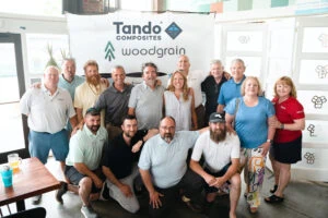 The team from Tando Composites and Woodgrain at kick-off event with the stars of TV's Maine Cabin Masters.