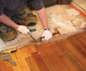 In the job shown, a double layer of 1/4-inch plywood and two vinyl floor coverings existed. The top vinyl and plywood layers were first removed.