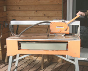 A Chicago Electric Power Tools Bridge Tile Saw, from Harbor Freight Tools, makes quick and easy work of cutting the large floor tiles. 