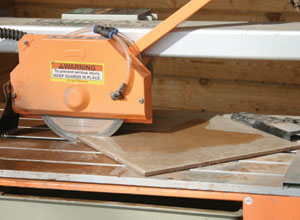 The tile is securely held in place on the table, and the wet-saw is pulled through the tile. Even 45-degree or other angled cuts are easy and precise.