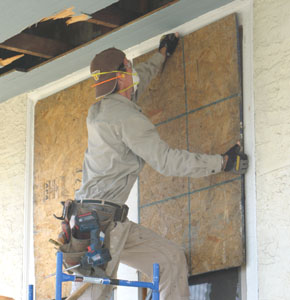 Part of having a plan in place means protecting what's not going to be trashed, in this case the brand new Simonton windows. I sheet them with OSB before starting demolition.