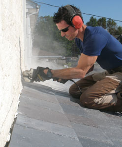 I kerf the stucco, install flashing bent on my sheet metal brake to trap the top course of shingles, and then seal with caulk.