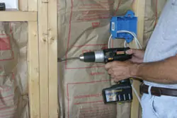 Demonstrating a drill going through multiple pieces of wood