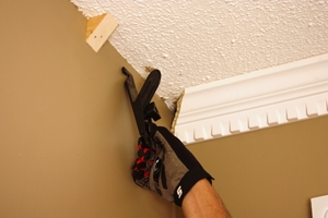 If you don't have an assistant, Crown Hangers provide a handy way to position the moulding while you fasten it in place.